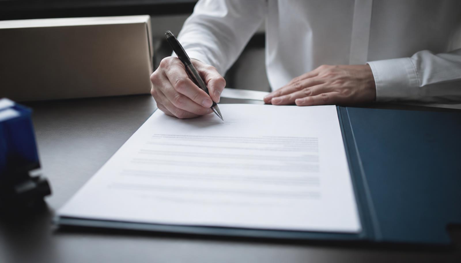 Signing a shipping services agreement at a desk